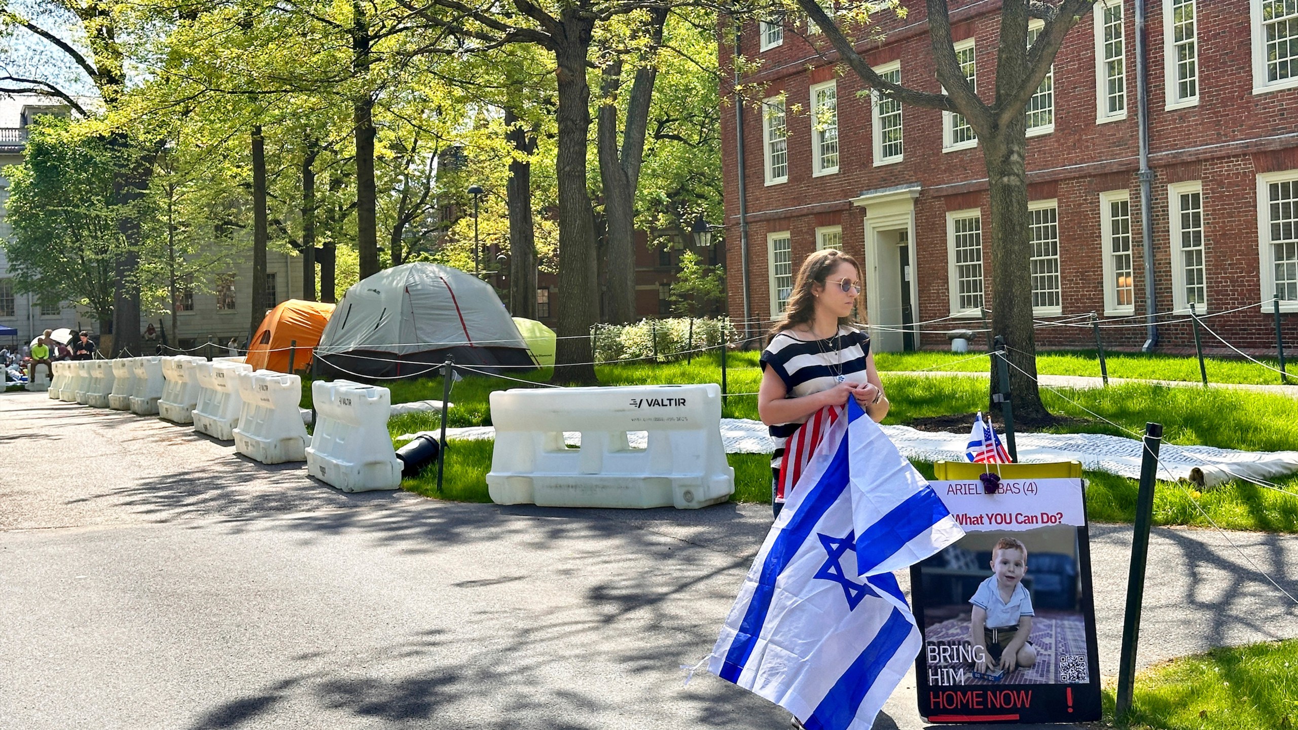 Rotem Spiegler, an alumni of Harvard University, stands near an encampment set up at the university to protest the war in Gaza, Tuesday, May 14, 2024, in Cambridge, Mass. The encampment was being voluntarily removed early Tuesday. (AP Photo/Michael Casey)