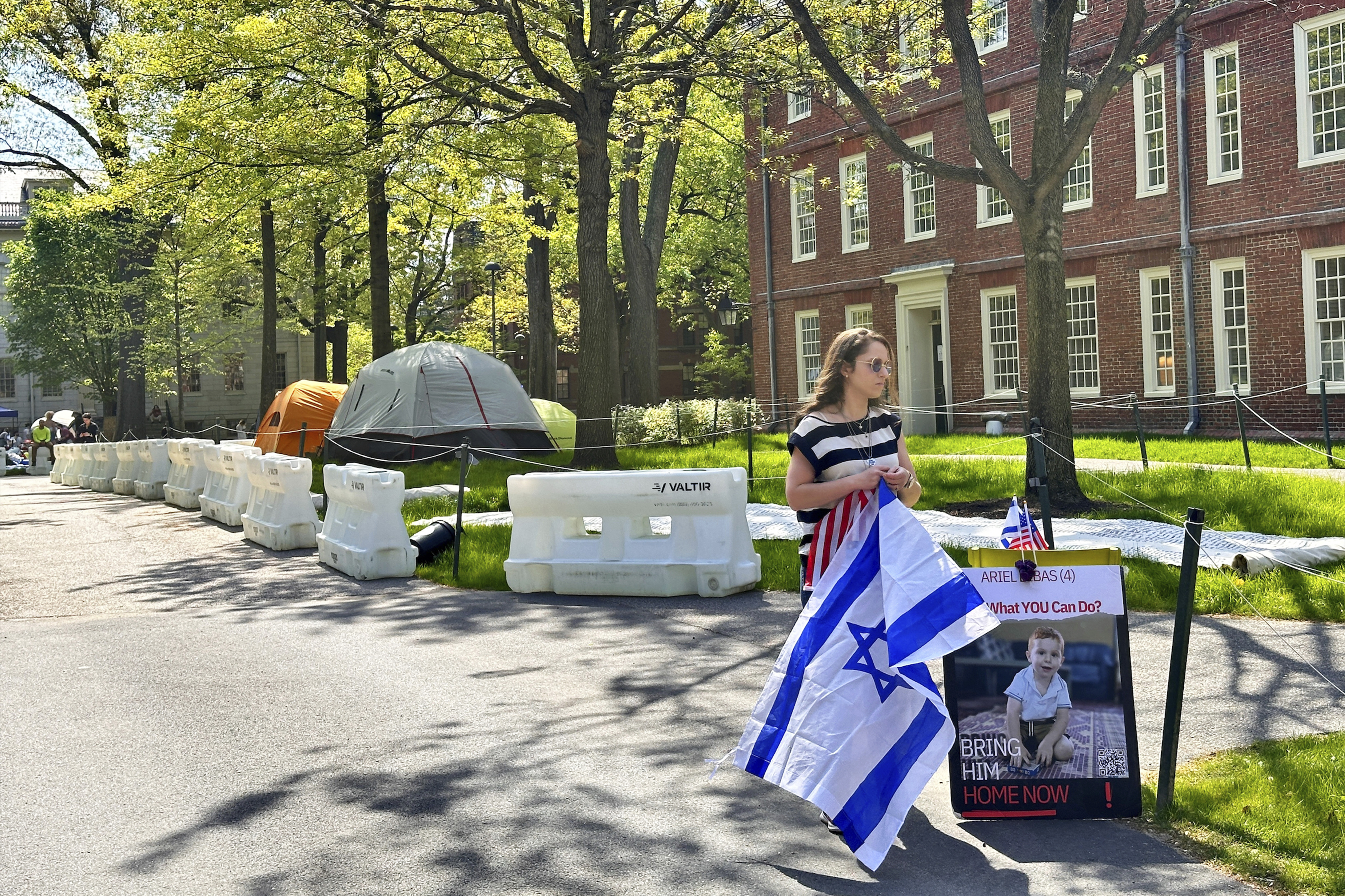 Rotem Spiegler, an alumni of Harvard University, stands near an encampment set up at the university to protest the war in Gaza, Tuesday, May 14, 2024, in Cambridge, Mass. The encampment was being voluntarily removed early Tuesday. (AP Photo/Michael Casey)