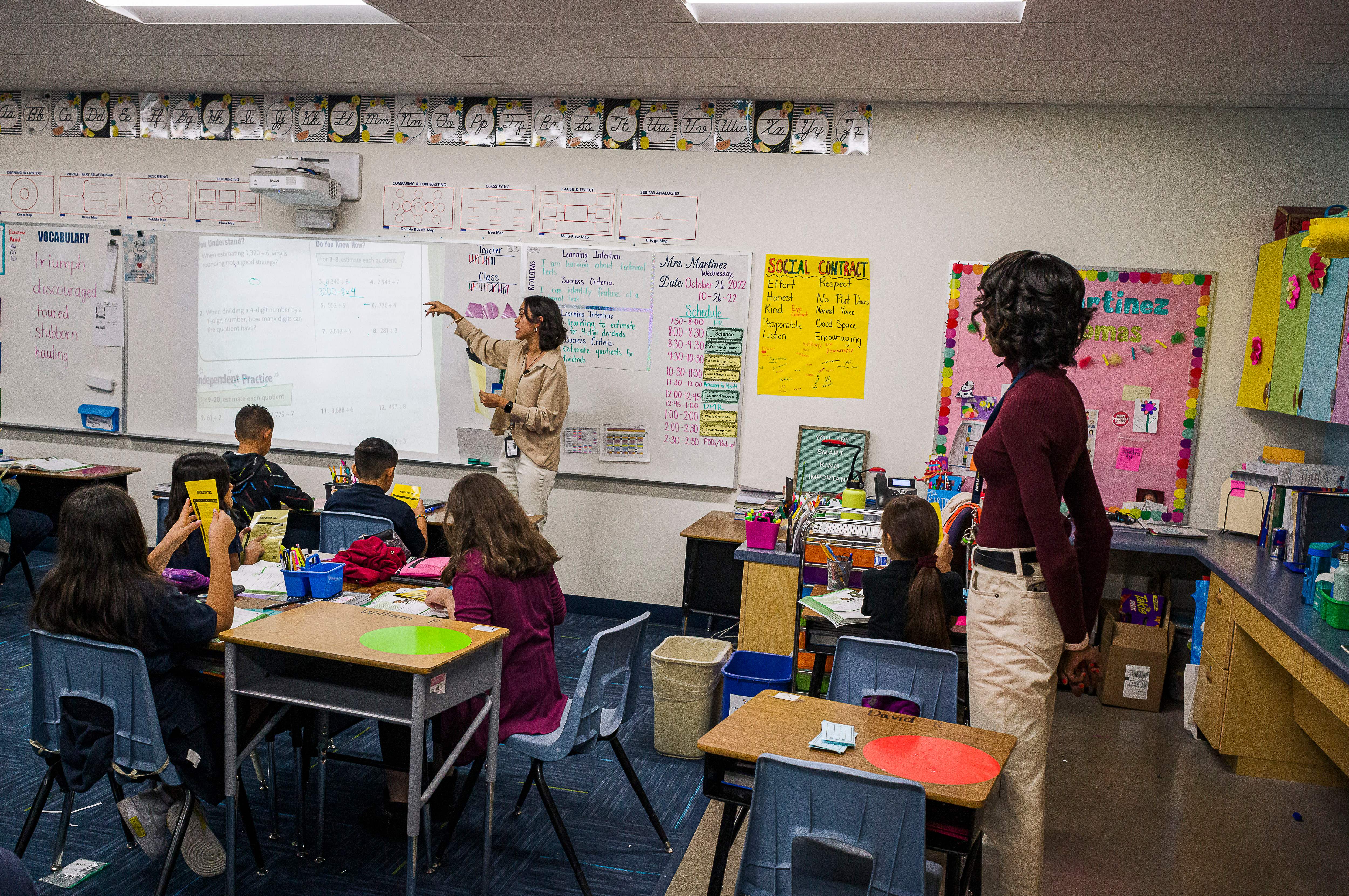 Aisha Thomas learns teaching skills with teacher Alexxa Martinez, in her classroom in Nevitt Elementary School, in Phoenix, Arizona, on October 26, 2022. (Photo by Olivier Touron/AFP via Getty Images)